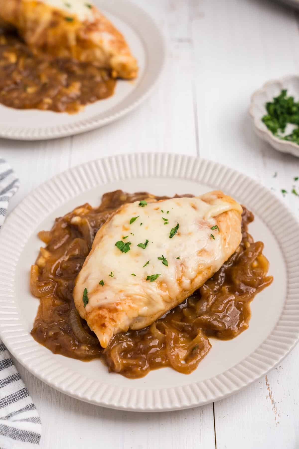 Overhead picture of completed French Onion Chicken on a white plate.