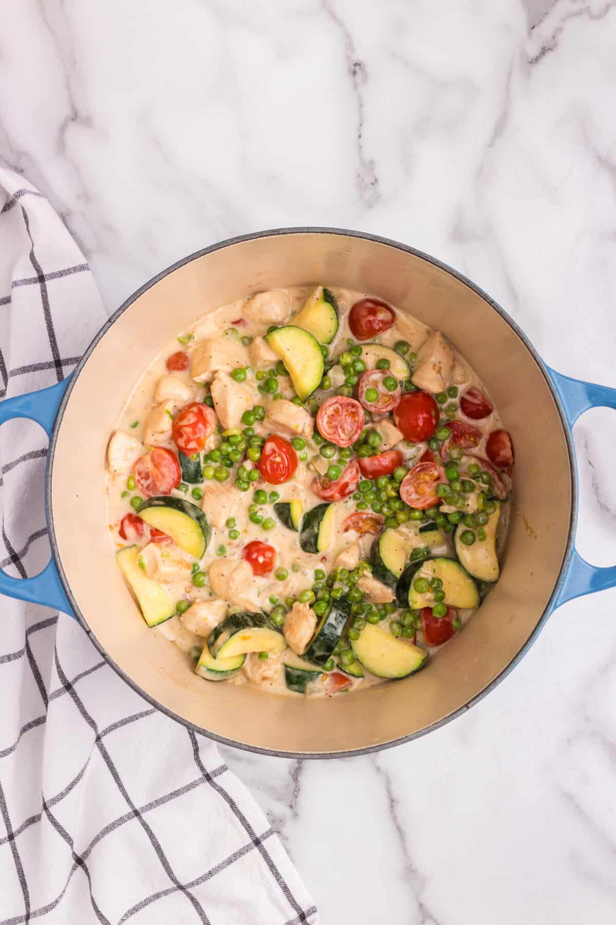 Overhead picture of chicken primavera ingredients in a pot cooked.