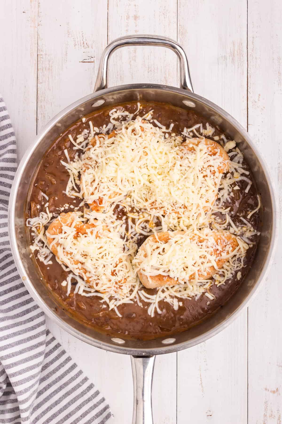 Overhead picture of french onion chicken with mozzarella cheese on top unmelted.