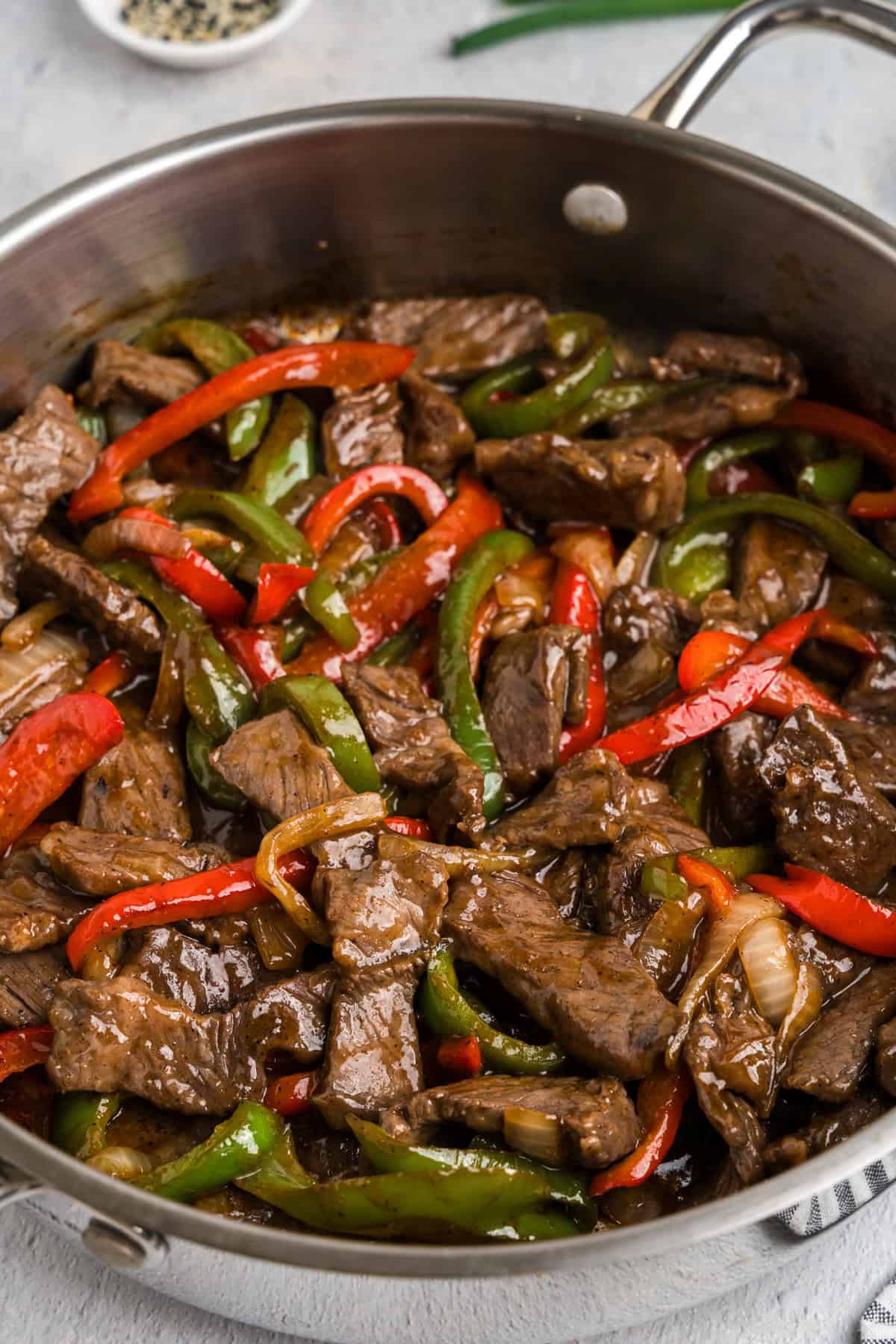 Close up picture of completed pepper steak in a pan.