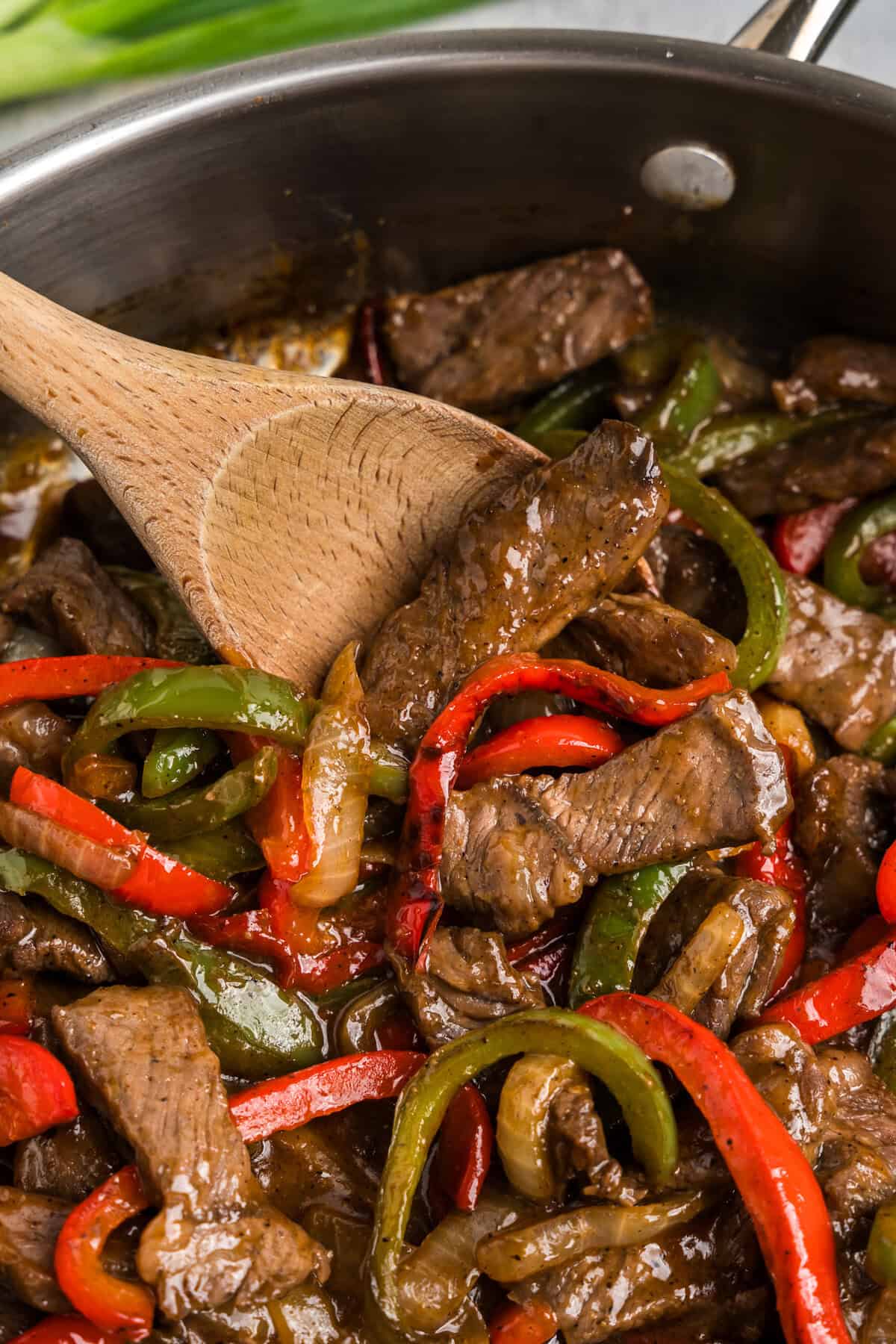 Close up picture of completed pepper steak in a pan.