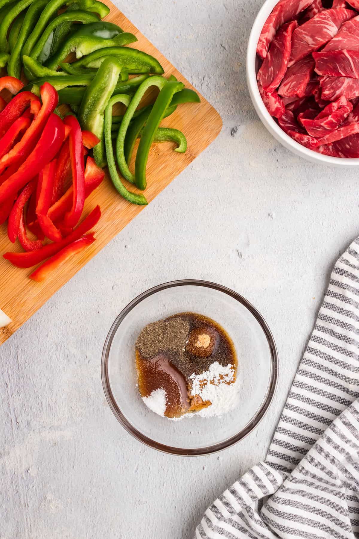 Overhead picture of marinate ingredients in a glass bowl unmixed.