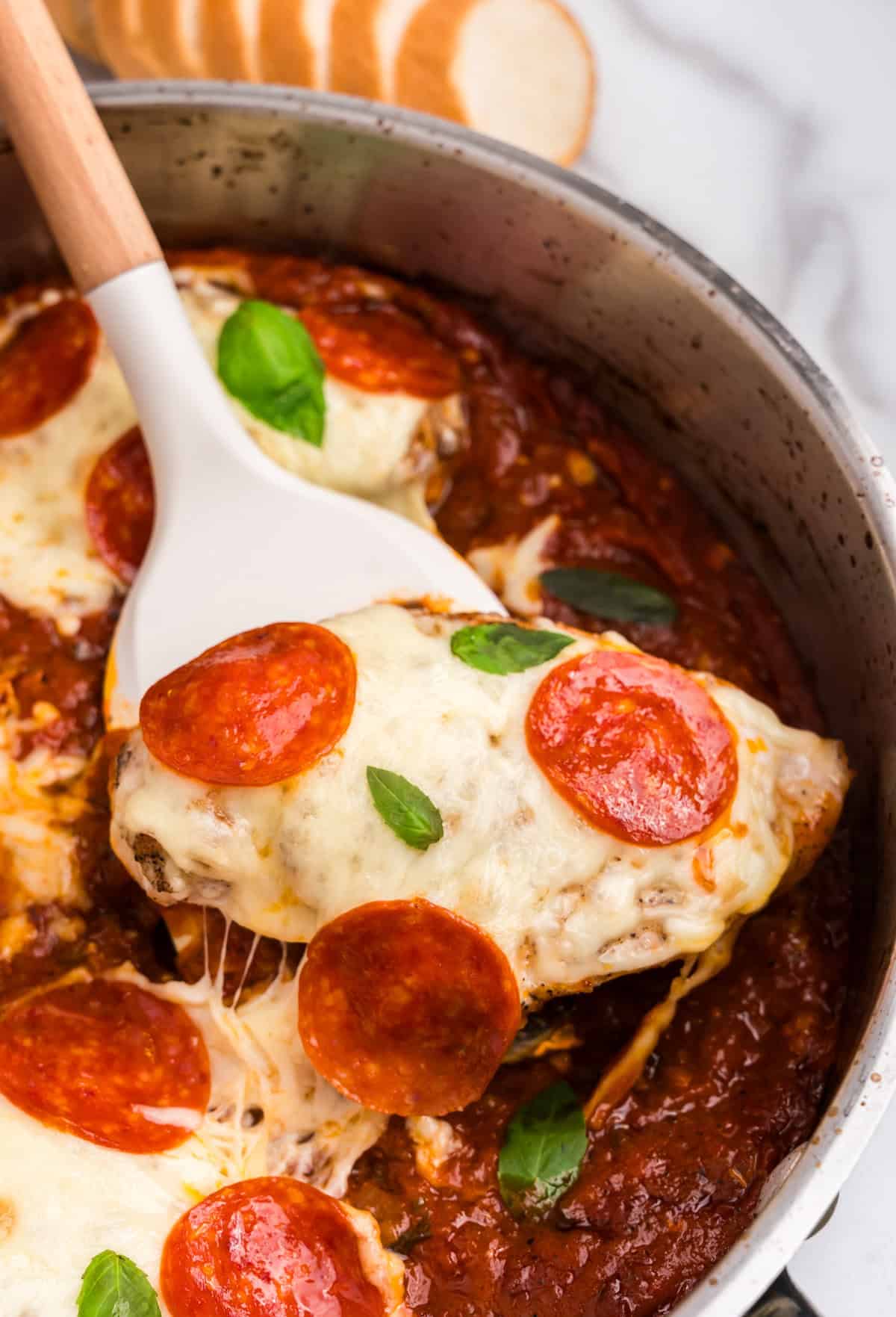 Pan with spatula lifting pizza chicken out of it