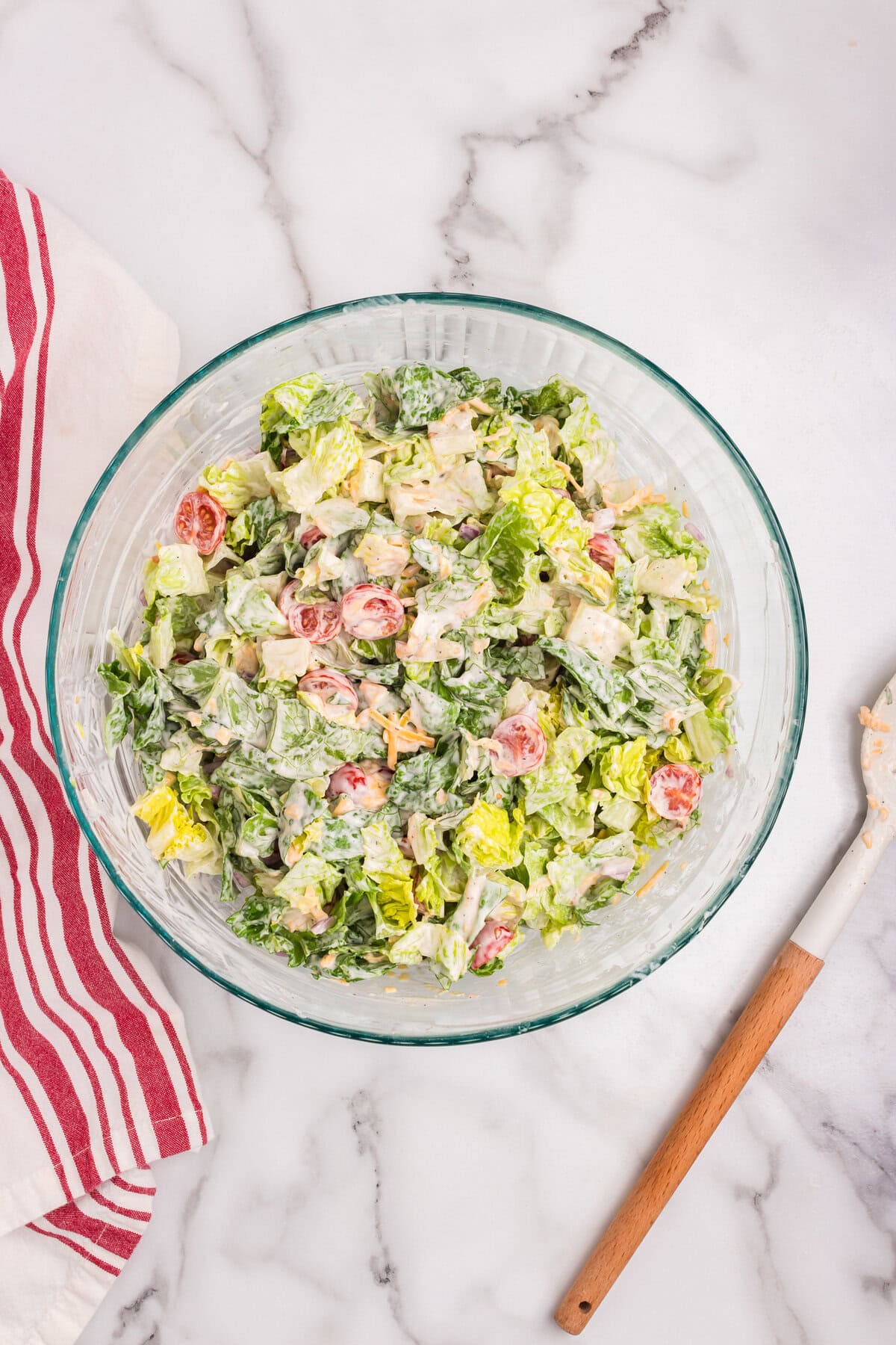 The salad is fully mixed, with all ingredients coated in the creamy dressing.