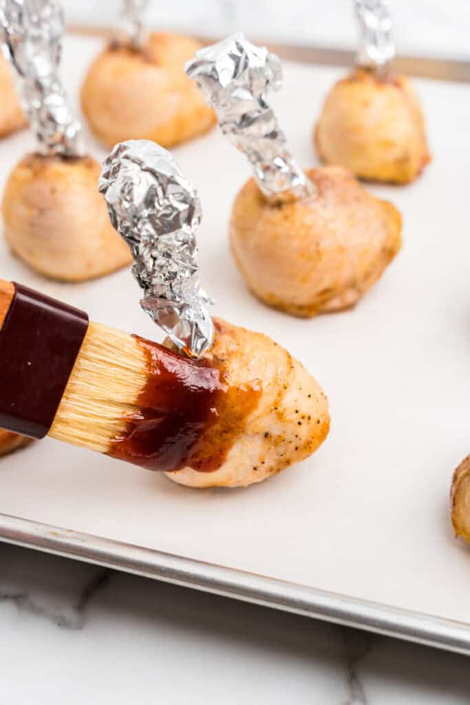Brushing Chicken Lollipops Drumsticks with BBQ sauce