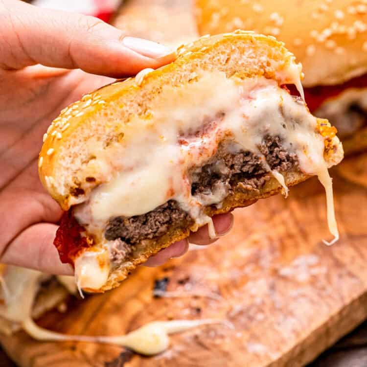 Italian Burger cut open with cheese melting out of it