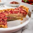 Closeup square image of Strawberry Rhubarb Pie slice being removed from pie plate