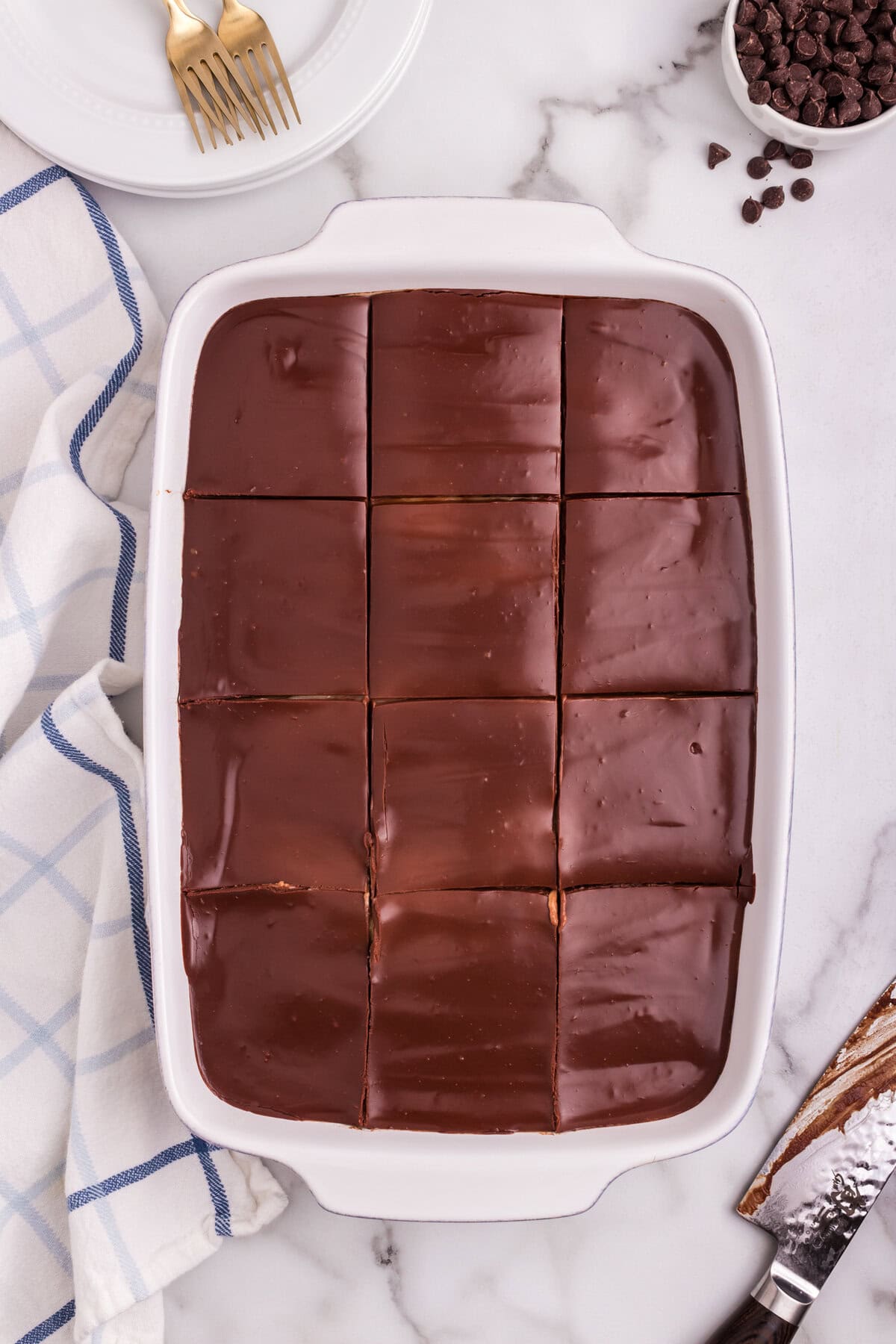 The finished Boston Cream Poke Cake cut into neat, even squares in the baking dish.