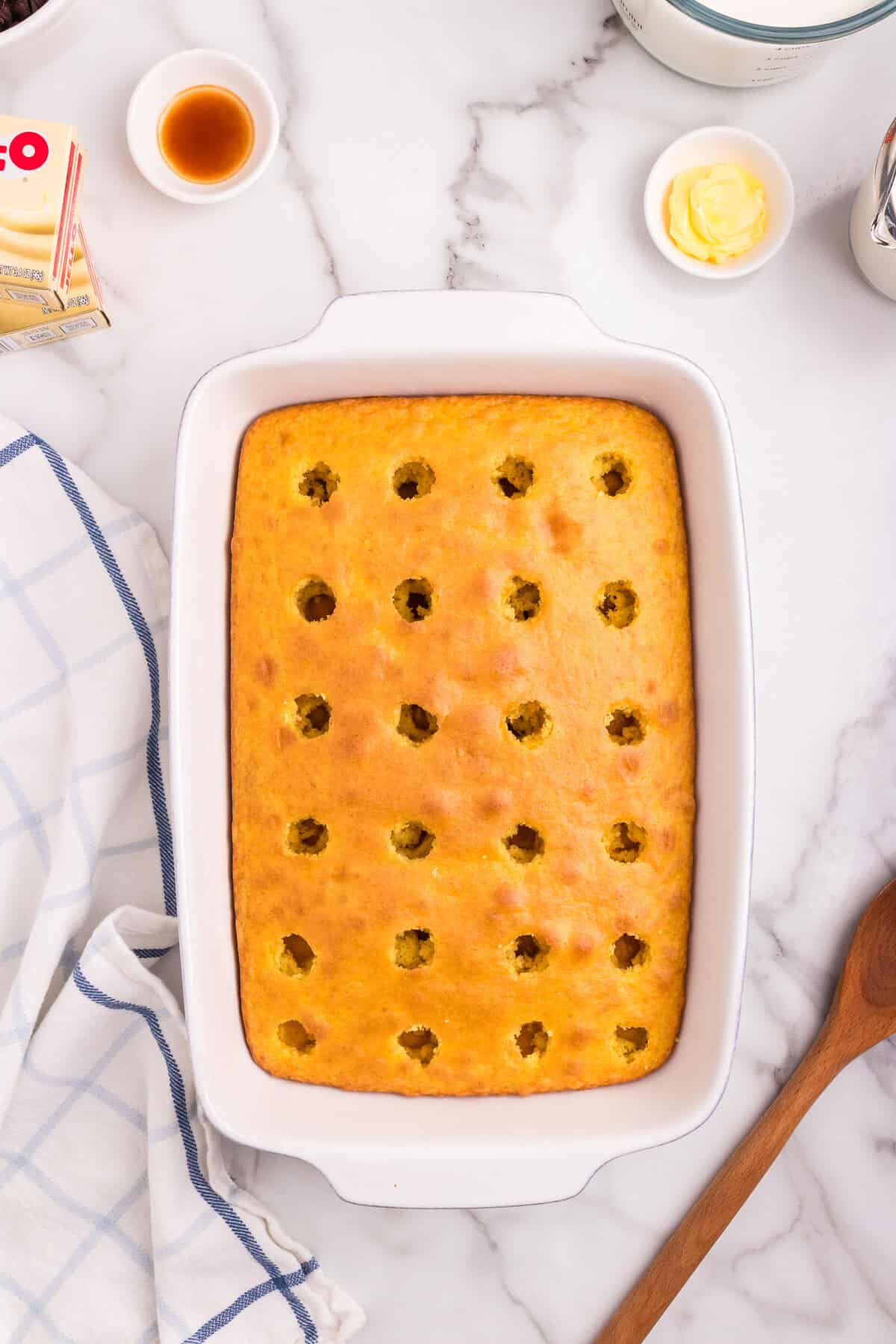 The entire cake surface is evenly poked with holes, covering the top in a grid-like pattern.