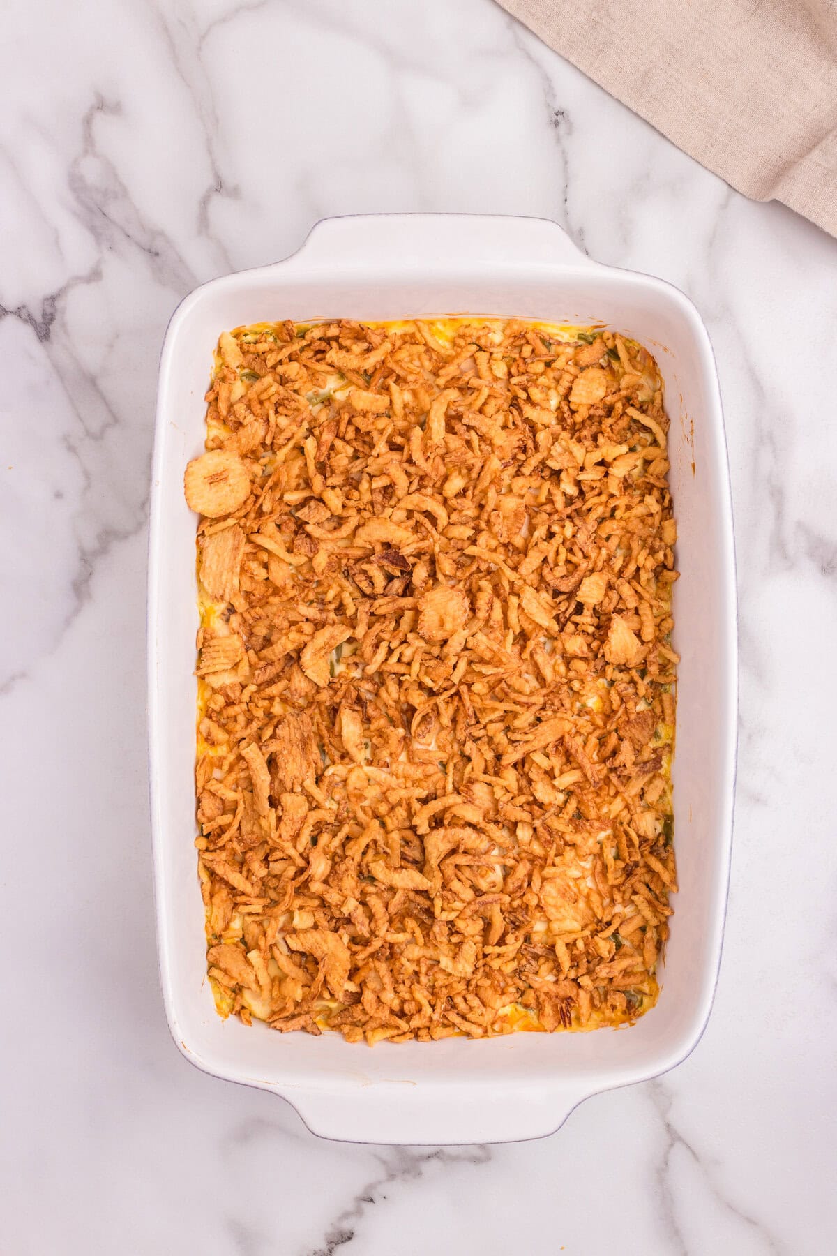 Fully baked French onion chicken casserole topped with a thick, golden layer of crispy fried onions.