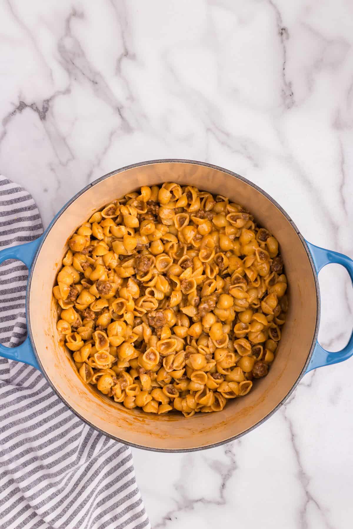 Cheddar cheese fully mixed into the cheeseburger pasta, creating a creamy consistency.