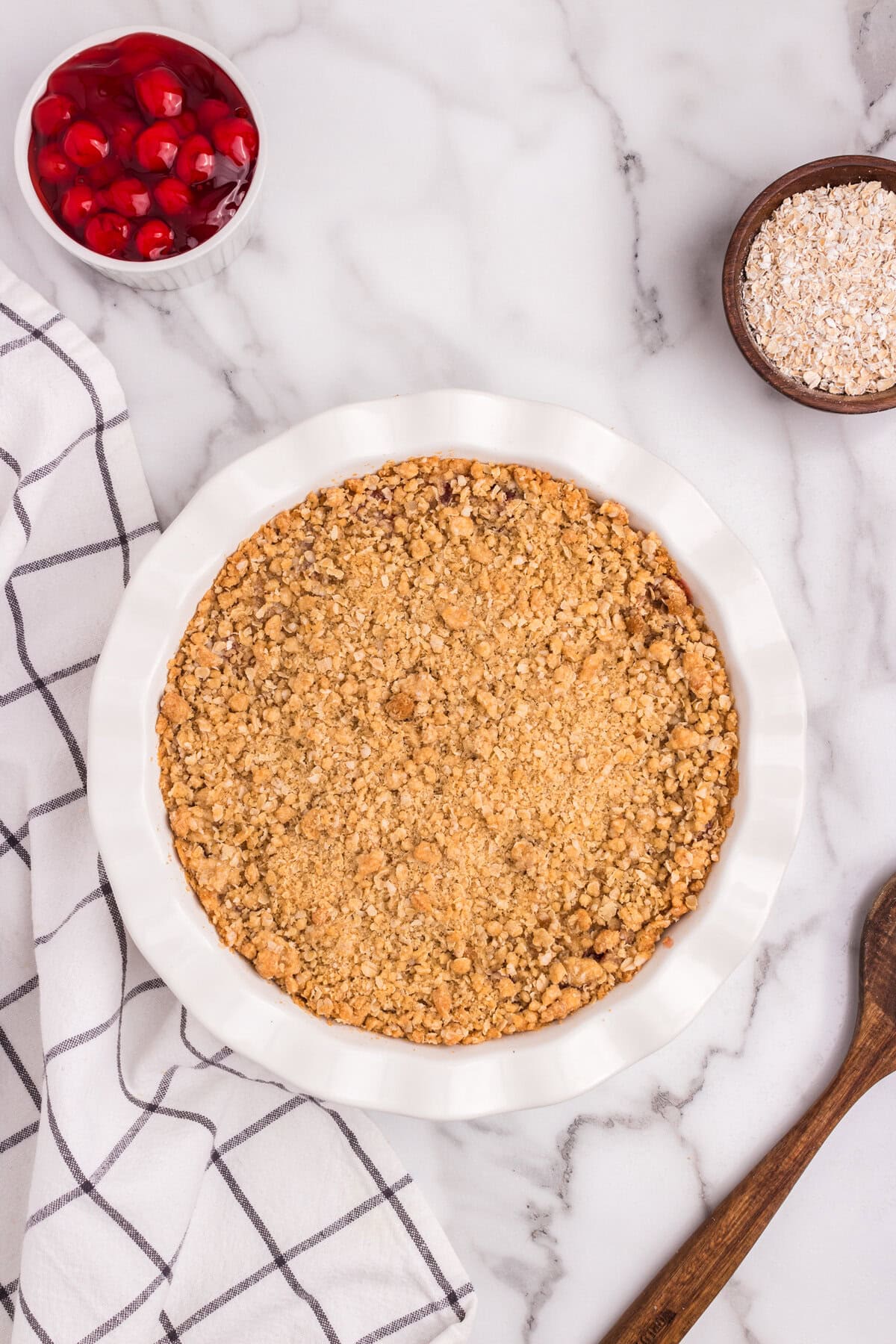 The finished pie, baked to golden brown perfection, sitting on a marble surface.
