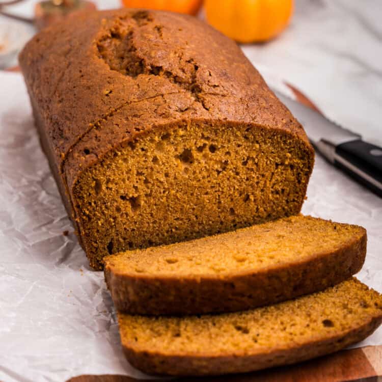 Loaf of pumpkin bread with a few pieces sliced