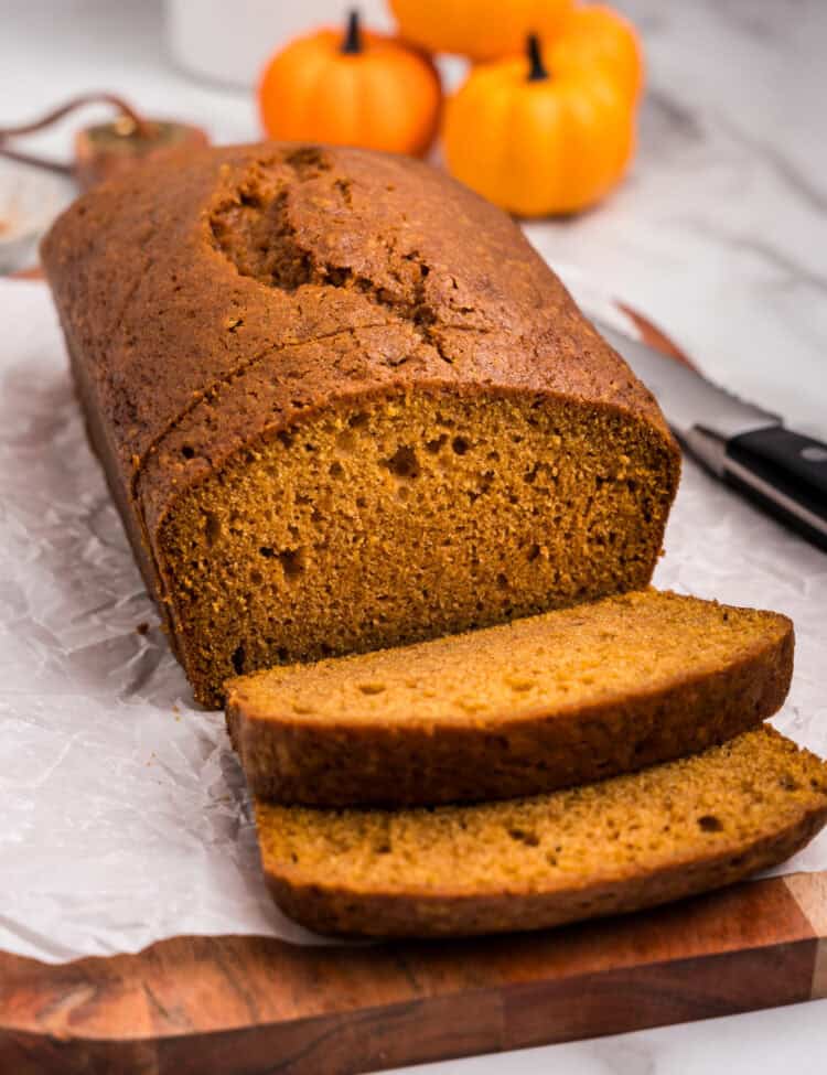 Loaf of pumpkin bread with a few pieces sliced