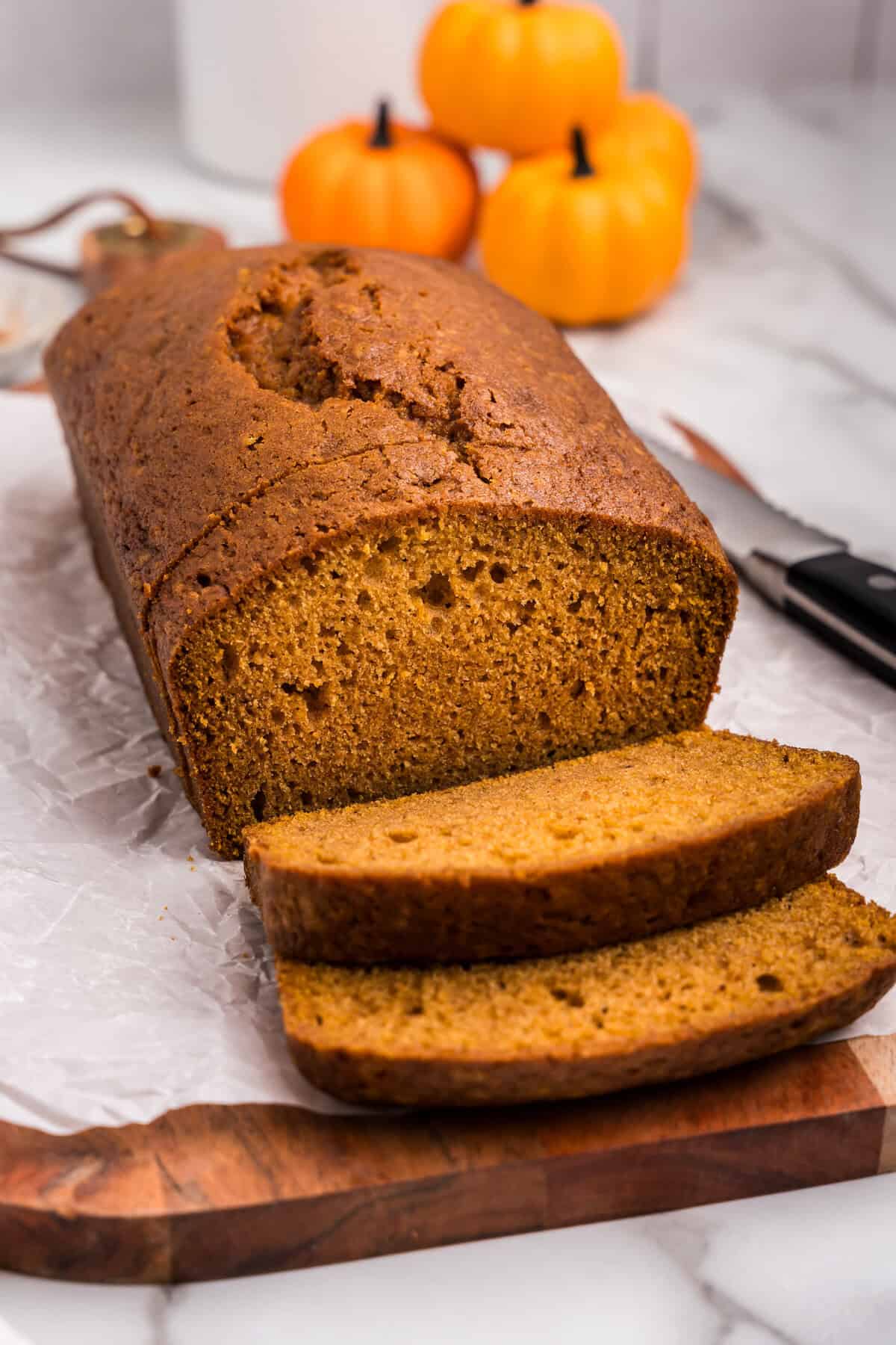 Loaf of pumpkin bread with a few pieces sliced