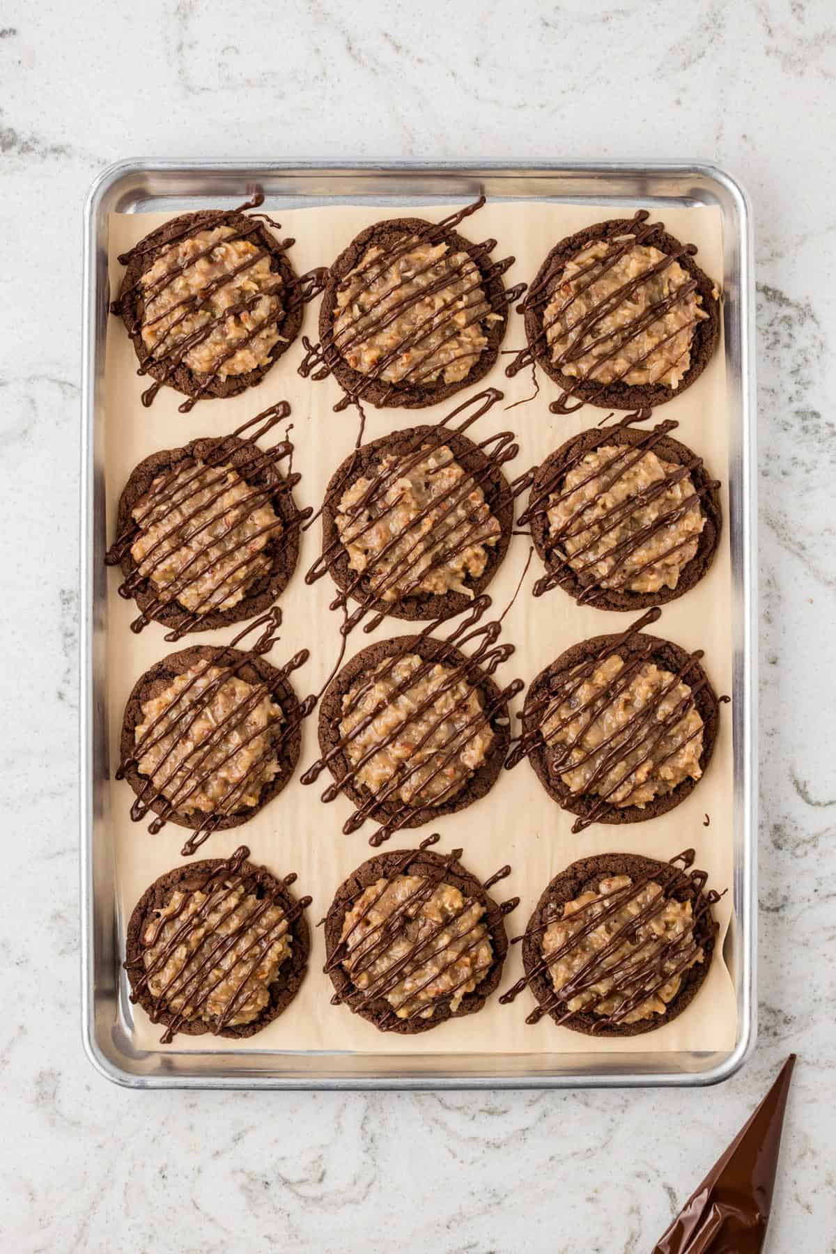 The same chocolate cookies, now topped with a caramel coconut pecan mixture and drizzled with melted chocolate.