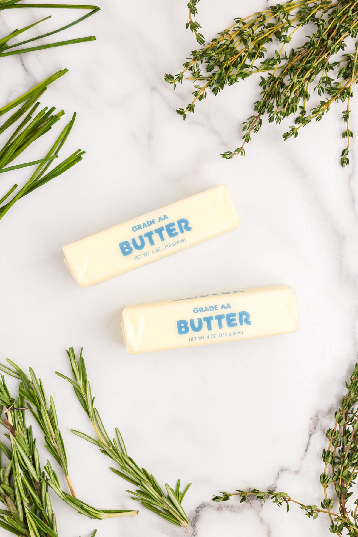 Two sticks of unsalted butter in wrapping